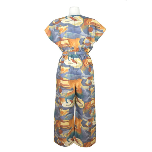 Upcycling summer overall for women with short sleeves. Upcycled cotton fabric with abstract brown rust blue beige pattern. V neck, loose fit with belt, pants length above the ankle